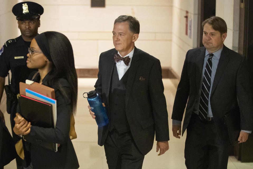 Deputy Assistant Secretary of State George Kent, second from right, arrives to appear before a joint House Committee on Foreign Affairs, Permanent Select Committee on Intelligence, and Committee on Oversight and Reform for a deposition on Capitol Hill in Washington, Tuesday, Oct. 15, 2019. (AP Photo/Manuel Balce Ceneta)