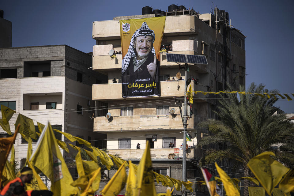 Palestinians chant slogans and wave yellow Fatah movement flags during a rally marking the 18th anniversary of the death of Fatah founder and Palestinian Authority leader Yasser Arafat in Gaza City, Thursday, Nov. 10, 2022. (AP Photo/Fatima Shbair)