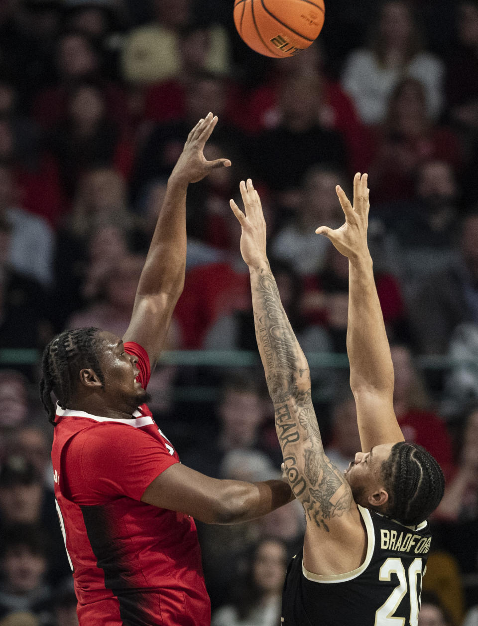 North Carolina State forward D.J. Burns, Jr. (30) shoots over Wake Forest forward Davion Bradford (20) in the first half of an NCAA college basketball game on Saturday, Jan. 28, 2023, at Joel Coliseum in Winston-Salem, N.C. (Allison Lee Isley/The Winston-Salem Journal via AP)