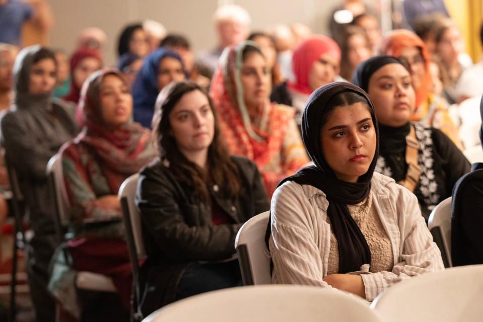 Community members listen to speakers during a "Stories from Gaza and Prayers for Palestine" gathering.