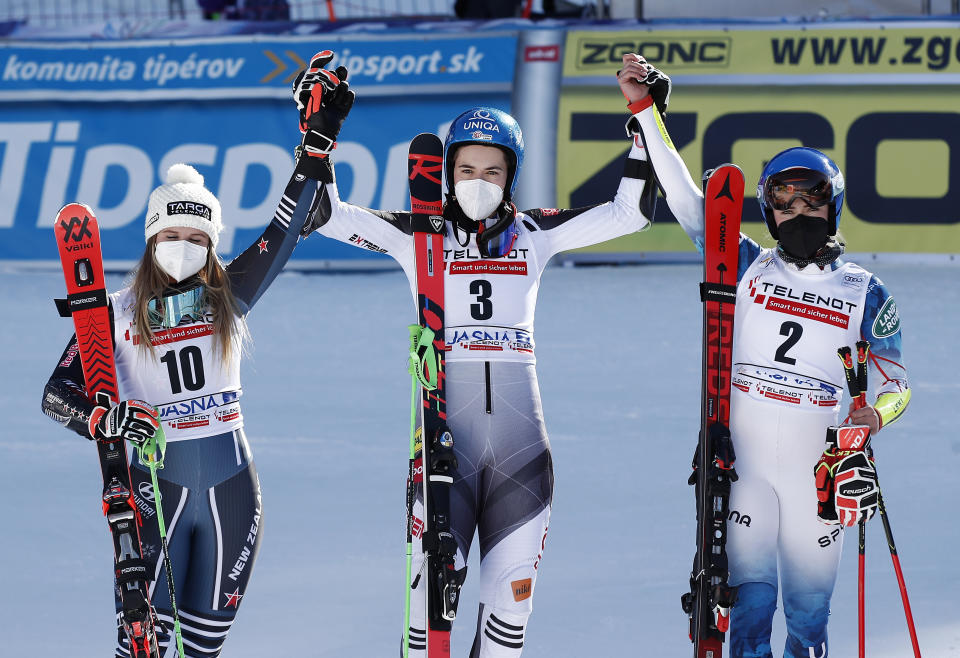 Slovakia's Petra Vlhova, center, winner of an alpine ski, World Cup women's giant slalom, celebrates in the finish area with second placed United States' Mikaela Shiffrin, right, and third placed New Zealand's Alice Robinson, in Jasna, Slovakia, Sunday, March 7, 2021. (AP Photo/Gabriele Facciotti)