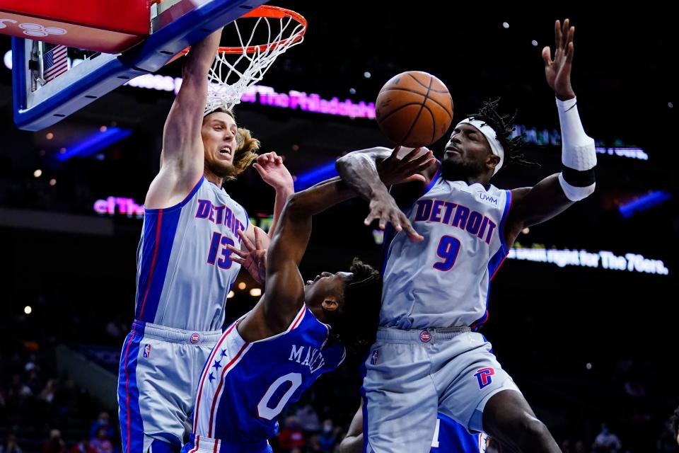 Philadelphia 76ers' Tyrese Maxey, center, cannot get a shot past Detroit Pistons' Jerami Grant, right, and Kelly Olynyk during the second half at Wells Fargo Center in Philadelphia on Thursday, Oct. 28, 2021.