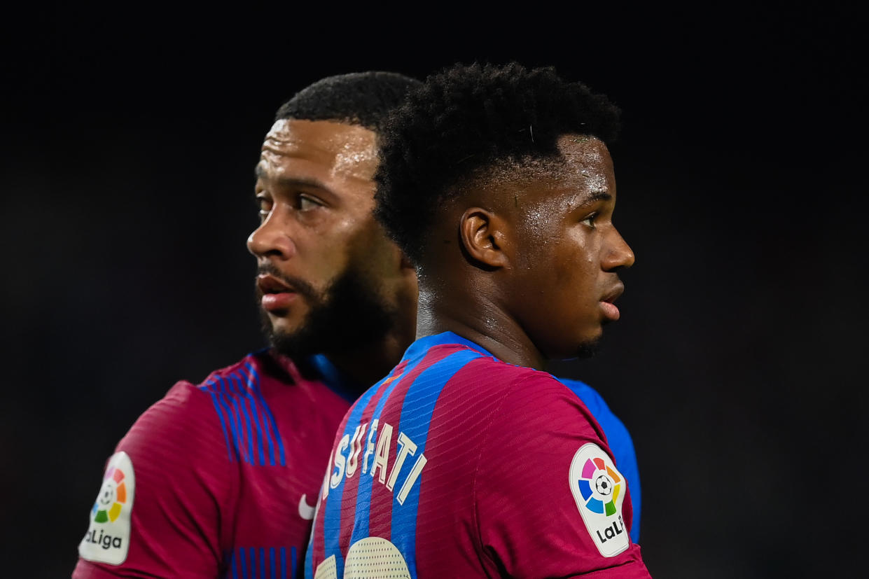 BARCELONA, SPAIN - OCTOBER 17: Memphis Depay and Ansu Fati of FC Barcelona look on during the La Liga Santander match between FC Barcelona and Valencia CF at Camp Nou on October 17, 2021 in Barcelona, Spain. (Photo by David Ramos/Getty Images)