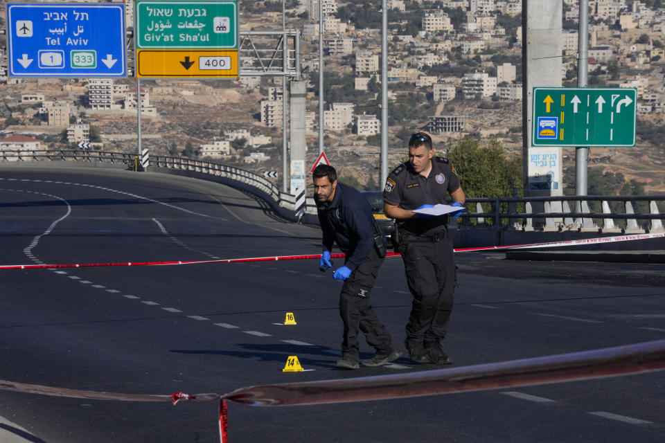 Israeli police inspect the scene of an explosion at a bus stop in Jerusalem, Wednesday, Nov. 23, 2022. Two blasts went off near bus stops in Jerusalem on Wednesday, injuring several people in what police said were suspected attacks by Palestinians. (AP Photo/Maya Alleruzzo)
