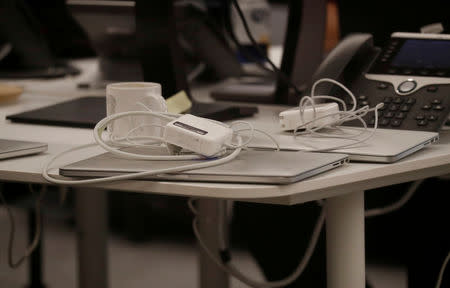 FILE PHOTO: Laptops sit on a table in the empty offices of Cambridge Analytica in Washington, D.C., U.S., May 2, 2018. REUTERS/Leah Millis/File Photo