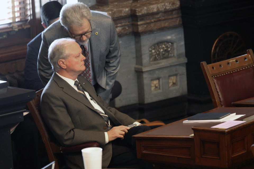 Kansas Senate Majority Leader Gene Suelletrop, left, R-Wichita, confers with his chief of staff, Eric Rucker, right, during a Senate session, Friday, April 9, 2021, at the Statehouse in Topeka, Kan. Suellentrop is facing a call to resign after being charged with drunken driving and trying to elude law enforcement over his March 16, 2021, arrest in Topeka. (AP Photo/John Hanna)