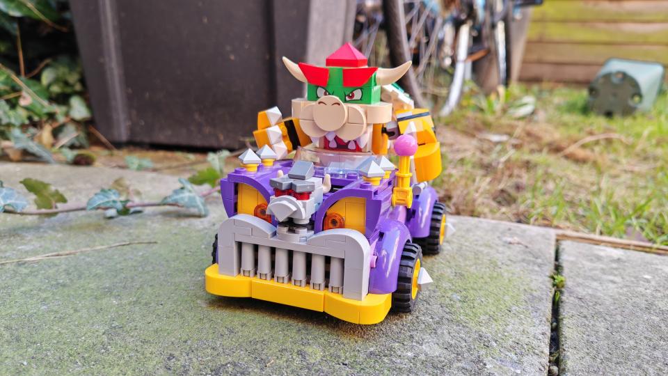 Lego Bowser's Muscle Car on a patio with grass in the background