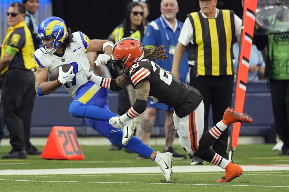 Los Angeles Rams wide receiver Puka Nacua, left, catches a pass in front of Cleveland Browns cornerback Mike Ford Jr. of an NFL football game Sunday, Dec. 3, 2023, in Inglewood, Calif. (AP Photo/Mark J. Terrill)