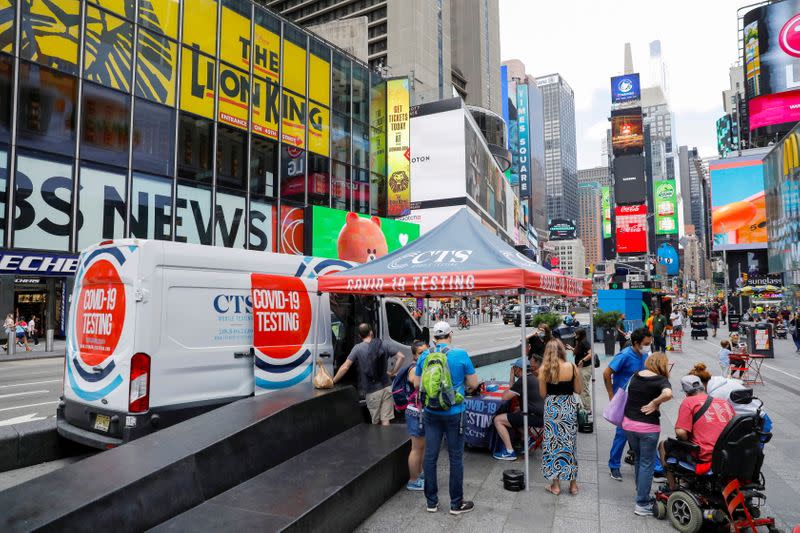 FILE PHOTO: People queue at a popup COVID-19 testing site in Times Square during the outbreak of the coronavirus disease in Manhattan, New York City