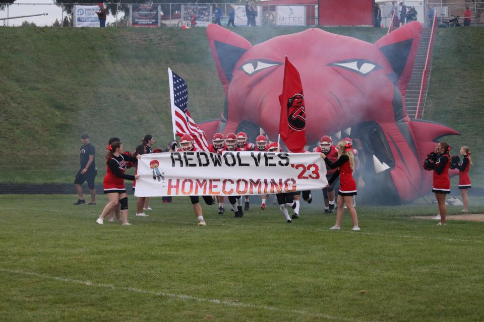 The Clinton football team come onto the field prior to Friday's game against Dundee.