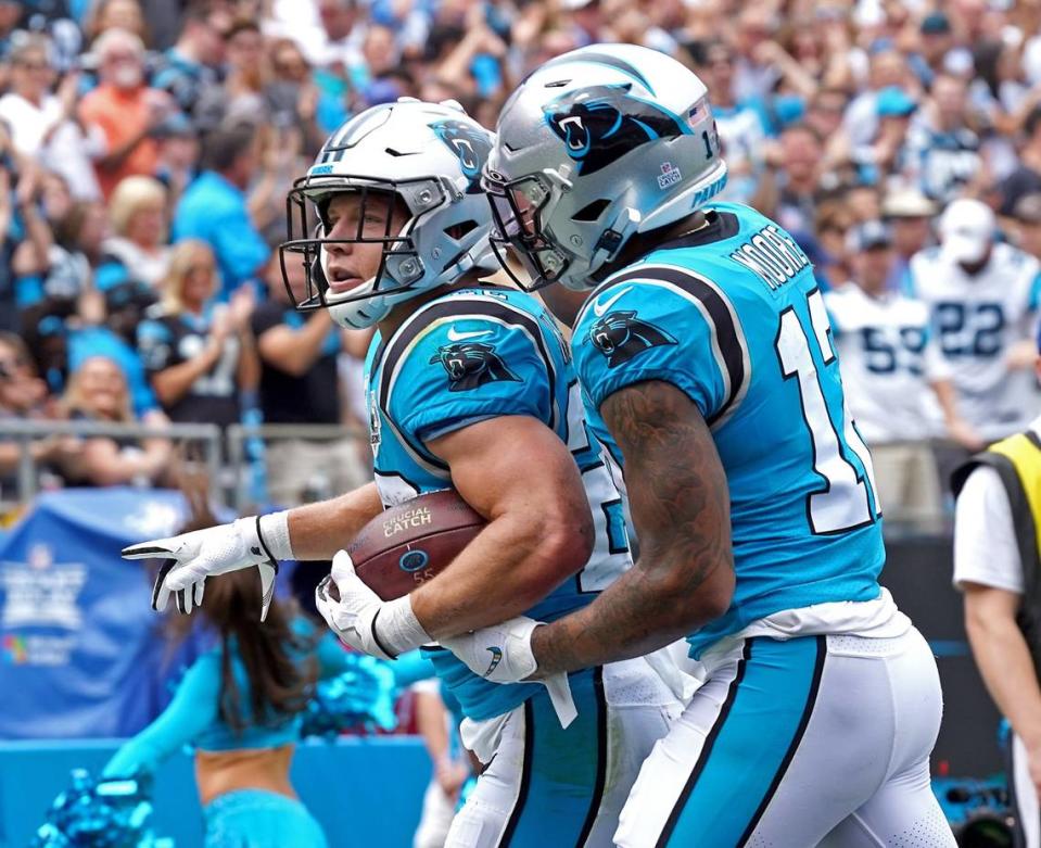 Carolina Panthers running back Christian McCaffrey is congratulated by wide receiver DJ Moore, right, after McCaffrey scored a touchdown after leaping and flipping over Jacksonville Jaguars cornerback Tre Herndon, left as linebacker Quincy Williams looks to assist during first quarter action at Bank of America Stadium in Charlotte, NC on Sunday, October 6, 2019. Jeff Siner/jsiner@charlotteobserver.com