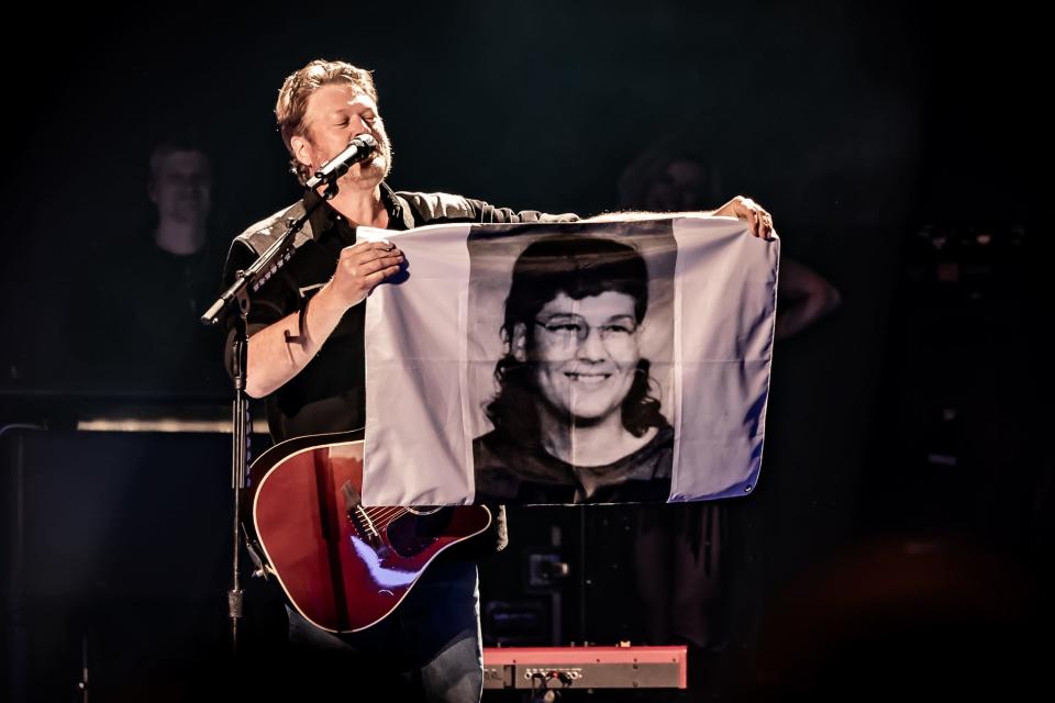 Blake Shelton holds a flag with photo of himself at Country Music Hall of Fame and Museum "All for the Hall" in Tulsa, Oklahoma, March 30, 2024