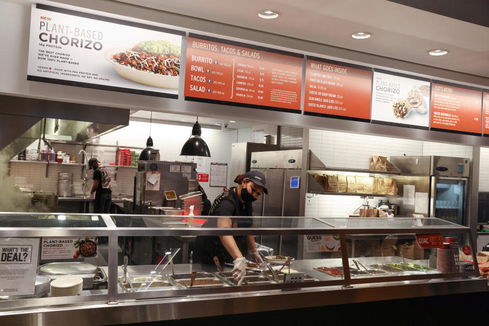 A person works in a Chipotle outlet in Manhattan, New York City, U.S., February 7, 2022. REUTERS/Andrew Kelly