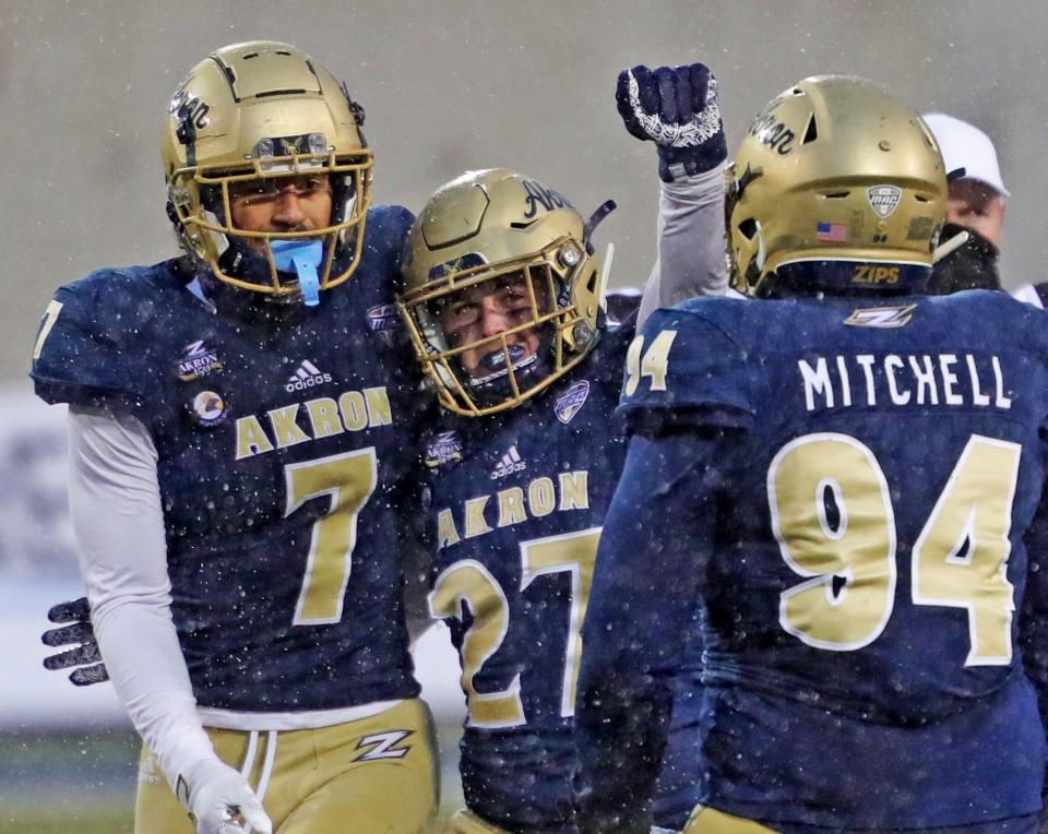 Akron Zips linebacker Bubba Arslanian (27) celebrates with teammates after sacking Bowling Green Falcons quarterback Matt McDonald (3) during the second half of an NCAA football game at InfoCision Stadium, Saturday, Dec. 5, 2020, in Akron, Ohio. [Jeff Lange/Beacon Journal]