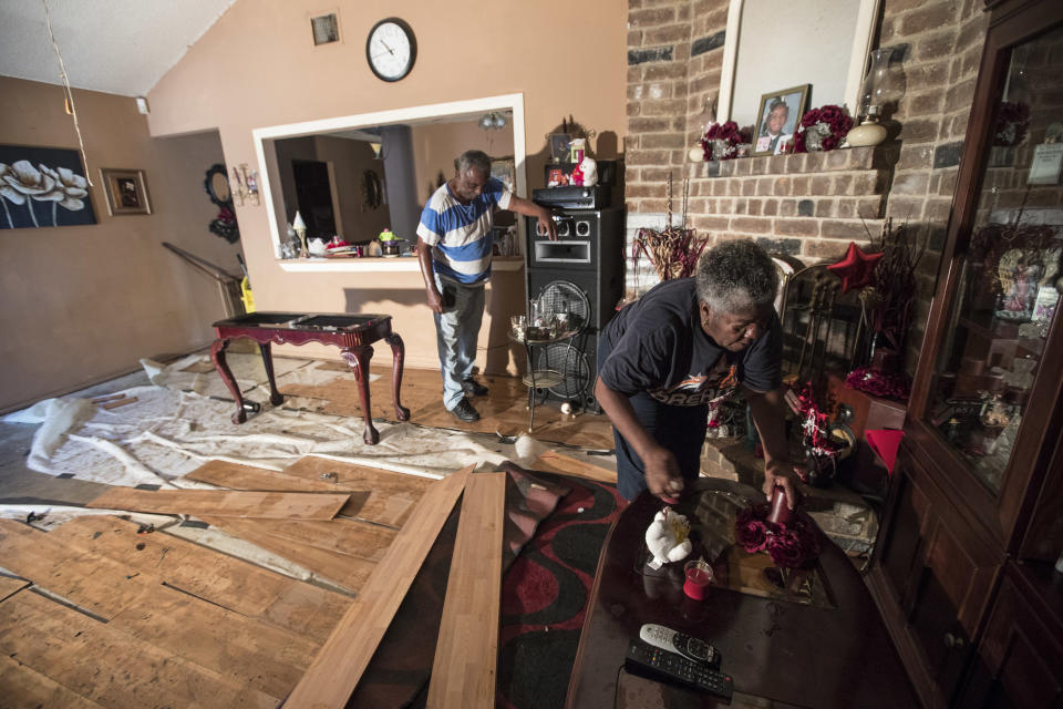 <p>Willie Johnson, left, and his wife Loicy, clean up their flood-damaged home in the aftermath of Tropical Storm Harvey in the Verde Forest subdivision of Houston on Thursday, Aug. 31, 2017. (Photo: Brett Coomer/Houston Chronicle via AP) </p>