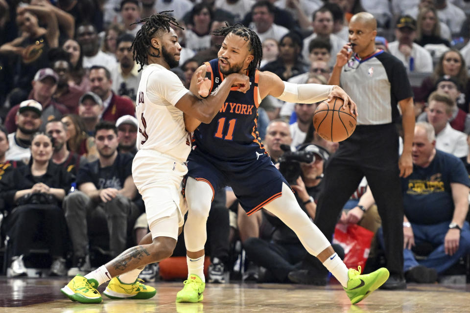 New York Knicks' Jalen Brunson (11) works against Cleveland Cavaliers' Darius Garland (10) during the first half of Game 1 in a first-round NBA basketball playoffs series Saturday, April 15, 2023, in Cleveland. (AP Photo/Nick Cammett)