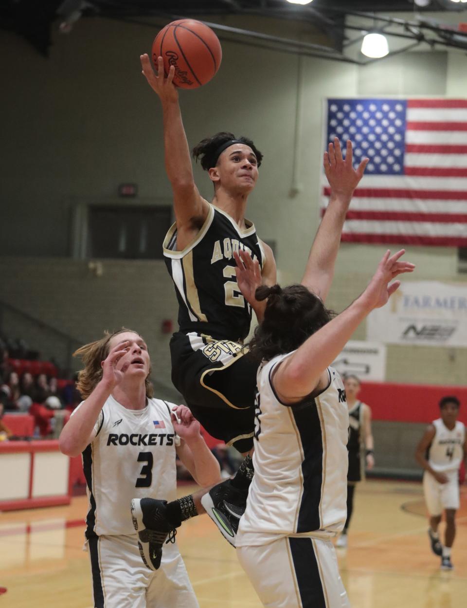 St. Thomas Aquinas' Julius Kimbrough drives for a shot against Lowellville in a boys Division IV district final at Struthers on Friday, March 4, 2022.