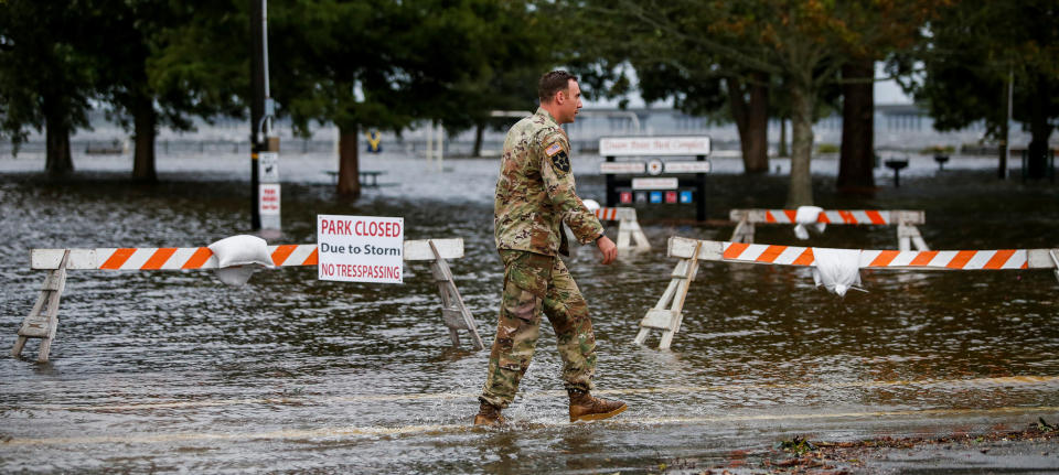 A U.S. Army member walks near the flooded Union Point Park Complex as Hurricane Florence comes ashore in New Bern on Thursday.
