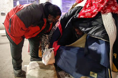 Richard S. Vargas, The Salvation Army Director of Community Social Services, checks on homeless Blanca Rodriguez for cold wellness checkup in Chicago, Illinois, U.S., January 31, 2019. REUTERS/Kamil Krzaczynski