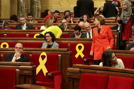 (L-R) Deputies Jordi Turull, Marta Rovira and Carme Forcadell take their seats before the start of the first session of Catalan Parliament after the regional elections in Barcelona, Spain, January 17, 2018. REUTERS/Albert Gea