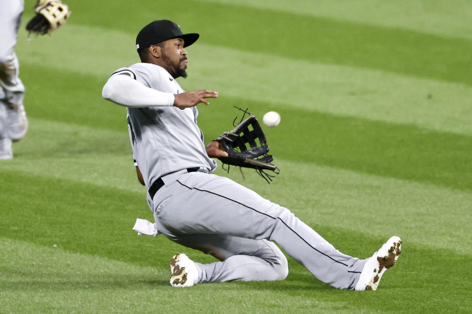 Chicago White Sox's Eloy Jiménez makes a sliding catch to get out Cleveland Indians' Tyler Naquin during the seventh inning of a baseball game, Monday, Sept. 21, 2020, in Cleveland. (AP Photo/Ron Schwane)