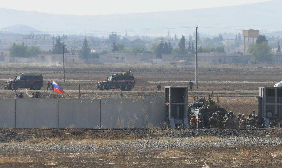 In this photo taken from the outskirts of Suruc, southeastern Turkey, Russian and Turkish forces enter Syria, as they begin their joint patrol, Tuesday, Nov. 5, 2019. Turkey and Russia launched joint patrols for the second time in northeastern Syria, under a deal that halted a Turkish offensive against Syrian Kurdish fighters who were forced to withdraw from the border area following Ankara's incursion. (AP Photo/Mehmet Guzel)