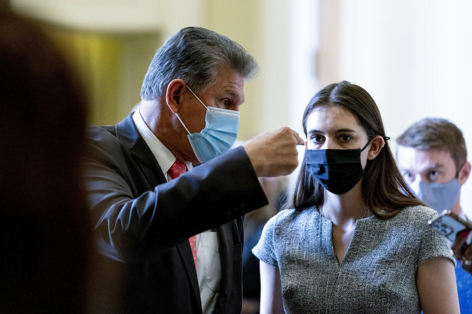 Sen. Joe Manchin, D-W.Va., speaks to an aide as he walks out of a Democratic policy luncheon as work continues on the Democrats' Build Back Better Act, massive legislation that is a cornerstone of President Joe Biden's domestic agenda, at the Capitol, in Washington, Tuesday, Sept. 14, 2021. (AP Photo/Andrew Harnik)