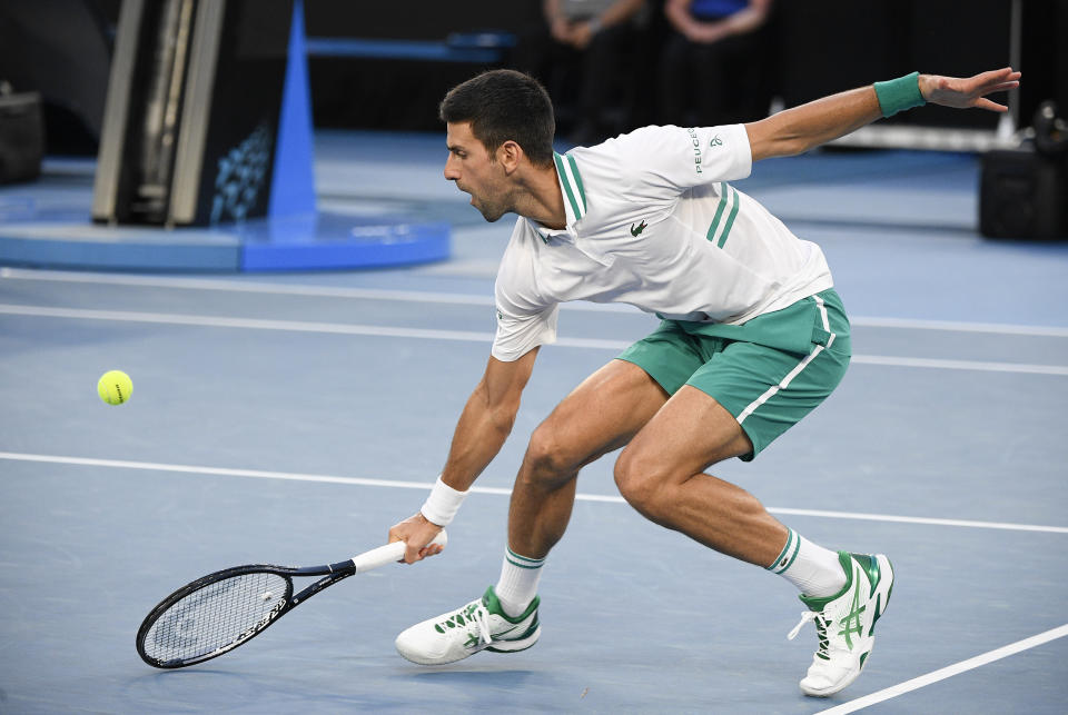 Novak Djokovic reaches for a ball. 