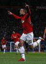 Manchester United's Robin van Persie celebrates scoring against Bayer Leverkusen during their Champions League soccer match at Old Trafford in Manchester, northern England September 17, 2013. REUTERS/Phil Noble (BRITAIN - Tags: SPORT SOCCER)