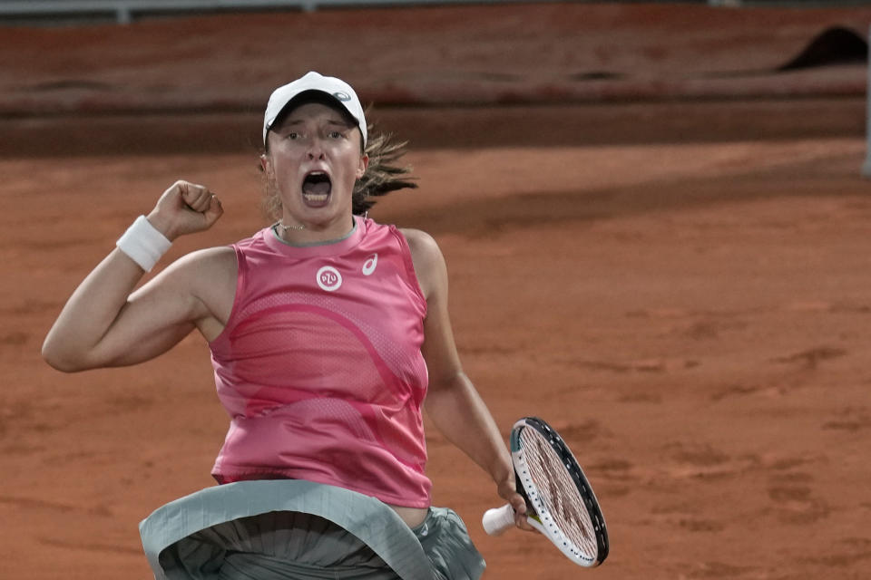 Poland's Iga Swiatek celebrates after defeating Ukraine's Marta Kostyuk during in fourth round match on day 9, of the French Open tennis tournament at Roland Garros in Paris, France, Monday, June 7, 2021. (AP Photo/Christophe Ena)