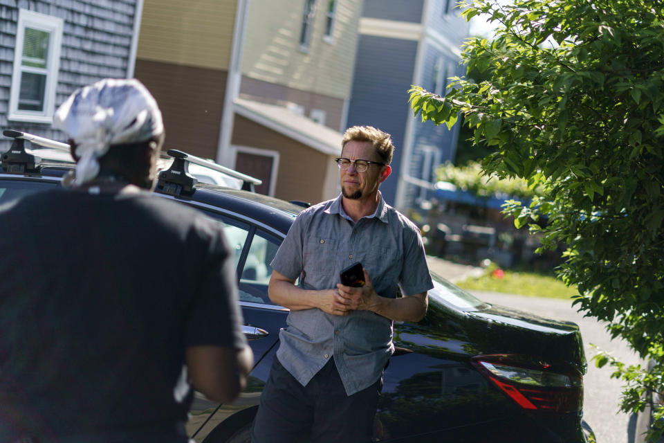 Scout, a transgender man who uses one name, talks to a neighbor outside his home in Providence, R.I., Wednesday, June 8, 2022. Among LGBTQ people, the 2020 census questionnaire only asked about same-sex couples living together, and Scout didn't live with his partner. So to compensate, he hounded his gay, cohabiting neighbors to respond and provide at least some visibility for the community. "I was stalking them to fill out the census form because mine didn't make a difference," said Scout. "There's no question I'm absolutely made invisible by the census." (AP Photo/David Goldman)