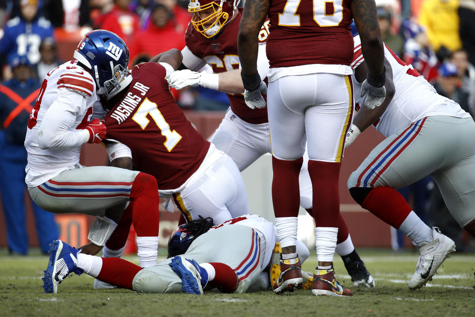 Ouch: Washington QB Dwayne Haskins suffered an ankle injury on this third-quarter play Sunday. (AP/Patrick Semansky)