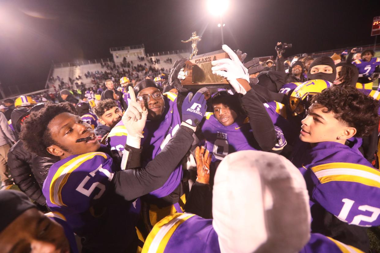 East/WOIS players hold high their Class A Section V Championship trophy.