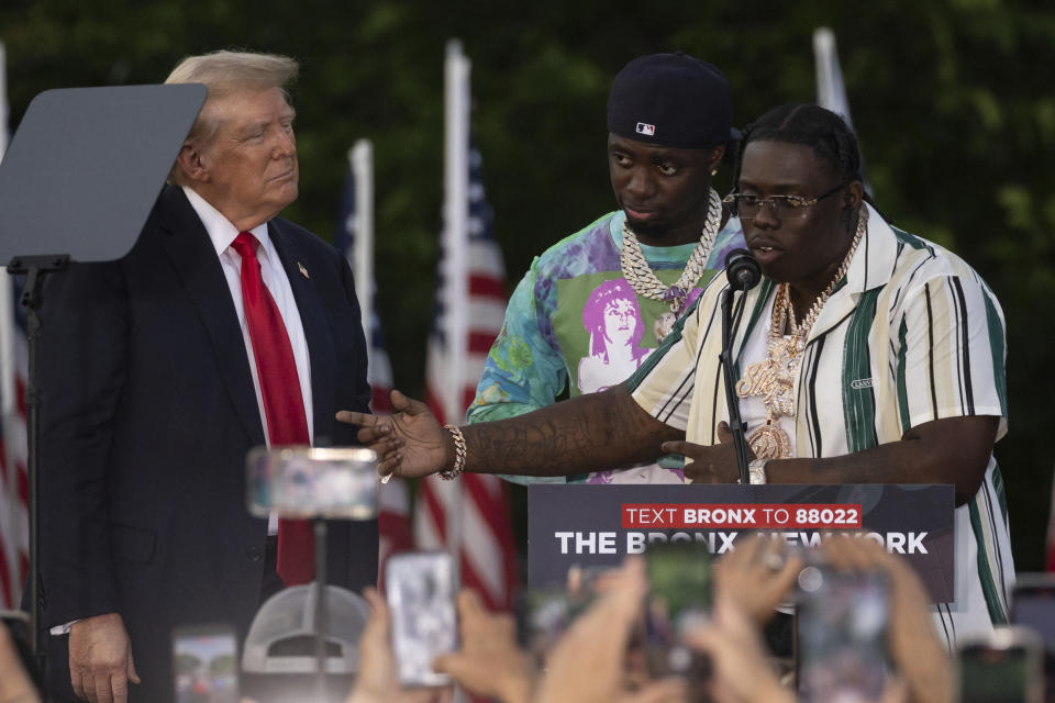 Rappers Sheff G, right, also known as Michael Williams, and Sleepy Hallow, center, also known as Tegan Chambers, join the Republican presidential candidate former President Donald Trump during a campaign rally in the south Bronx, Thursday, May. 23, 2024, in New York. (AP Photo/Yuki Iwamura)