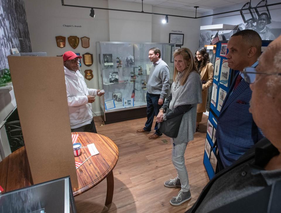Joseph McDuffie, left, gives a tour to Florida Power & Light executives at the General Daniel "Chappie" James Museum in Pensacola on Monday, Dec. 19, 2022.  Florida Power & Light presented a $25,000 check to the General Daniel "Chappie" James Flight Academy.