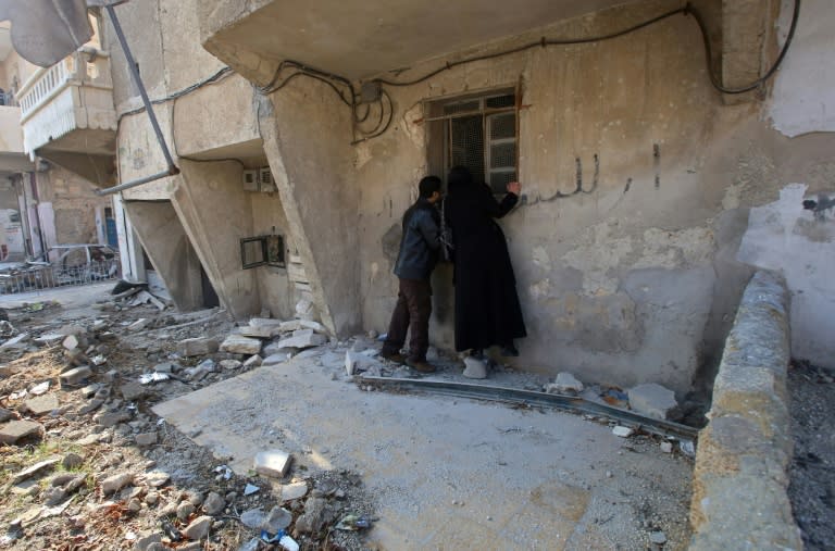 Kefa Jawish and her husband Tajeddin Ahmed check their housein Aleppo's Haydariya neighbourhood on December 4, 2016 for the first time in four years