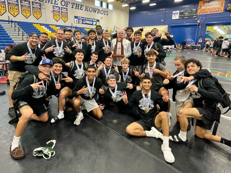 The Palmetto Ridge wrestling team celebrates winning the 3A Dual State Championship in Kissimmee on January 22, 2022.