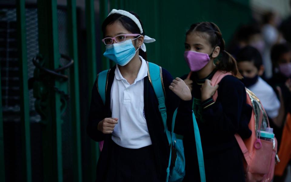 Children line up to enter a school amid the Covid-19 pandemic in Buenos Aires, Argentina on Monday April 19 - Victor R.Caivano / AP