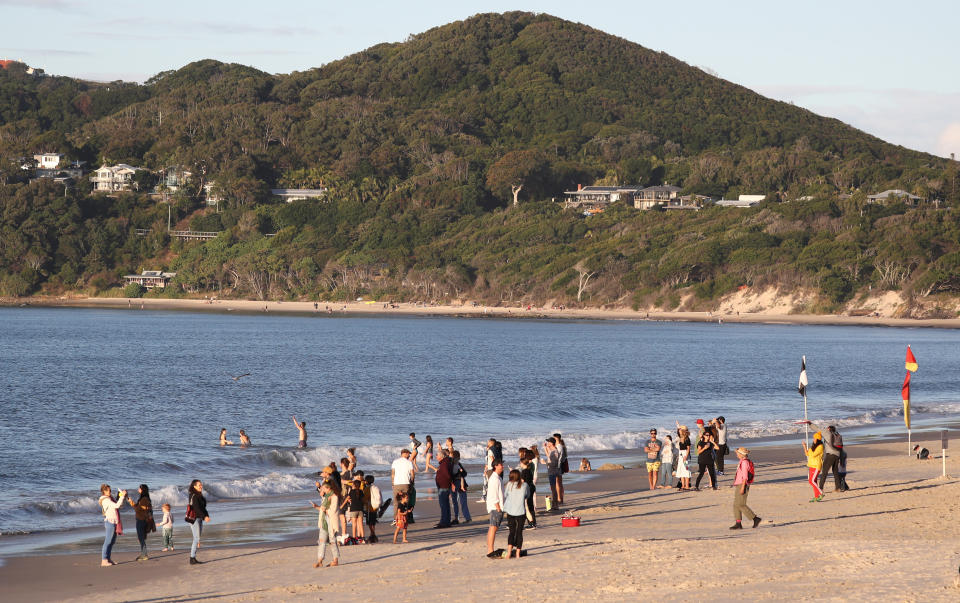 Beachgoers are seen on the sand at Byron Bay, NSW, Saturday, June 6, 2020. Coronavirus restrictions are slowly being eased across Australia with states and territories at different stages on the roadmap to reopen the nation. (AAP Image/Jason O'Brien) NO ARCHIVING
