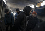 Bracing against harsh winter weather inside an abandoned hangar migrants are gathered near the Hungarian border, outside of the village of Majdan, Serbia, Tuesday, Jan. 11, 2022. Hungary's nationalist prime minister, Viktor Orban, is keen to use the threat of migrants at his country's southern border to give him an advantage in upcoming elections. But the scale of migration pressure claimed by Orban is drawn into question by statistics from neighboring Serbia and the European Union's border agency. (AP Photo/Bela Szandelszky)