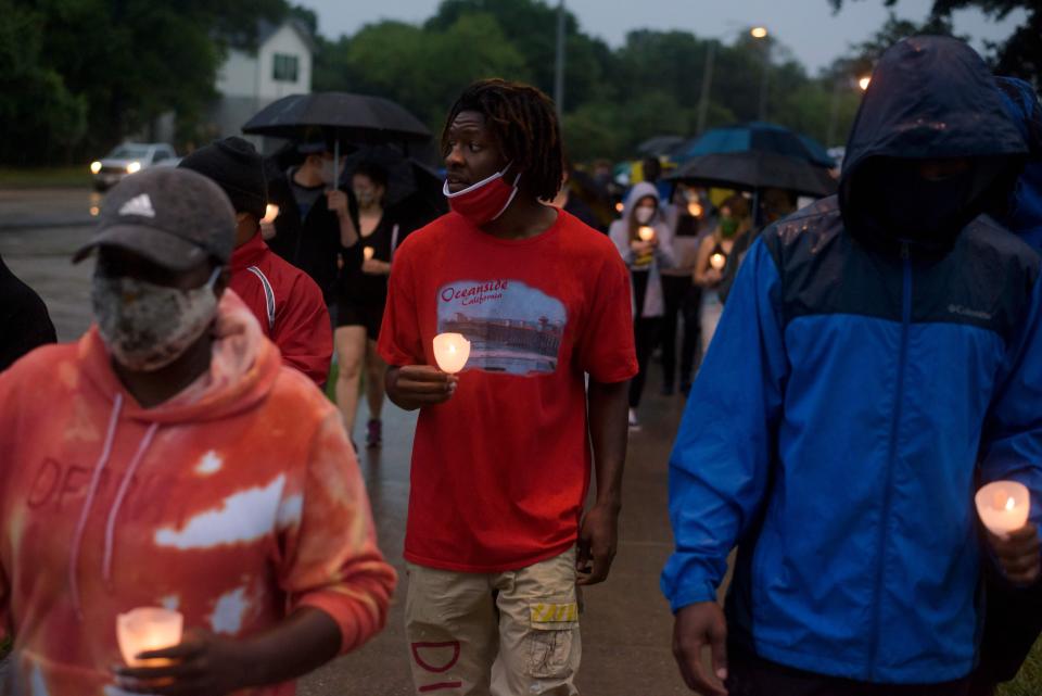 People in Houston march as they mourn the death of George Floyd during a candlelight vigil at Resurrection Metropolitan Community Church on May 31. (Photo: MARK FELIX via Getty Images)