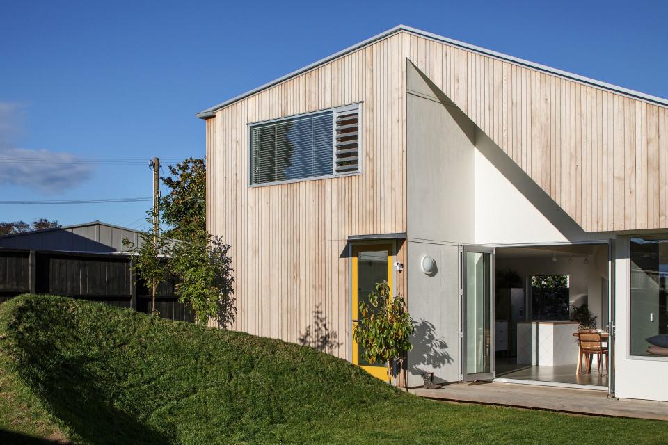 The crest of grass in the couple’s front yard was once referred to as “the Nike swoosh” by a member of the construction crew. “The organic shape provides a nice contrast against the angular façade of the house,” is how Henri puts it.