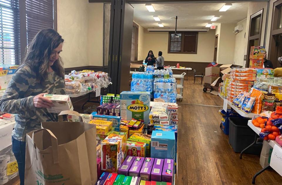 Community leaders and volunteers collected and distributed food Monday in the Grier Heights neighborhood. Here, Kathleen Bambrick Meier of CrossRoads Corporation for Affordable Housing and Community Development sorts donations at the Grier Heights Community Center.