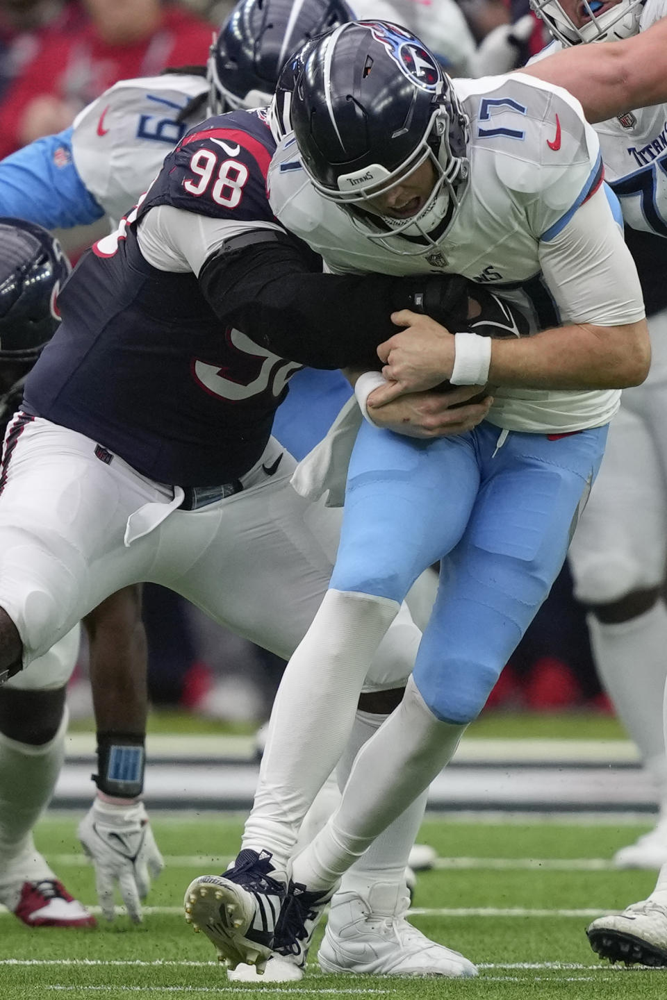 Houston Texans defensive tackle Sheldon Rankins (98) sacks Tennessee Titans quarterback Ryan Tannehill (17) during the second half of an NFL football game Sunday, Dec. 31, 2023, in Houston. (AP Photo/David J. Phillip)