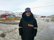 In this May 7, 2020 photo provided by Aaron Watson, his son, Owen, 12, stands for a portrait in Iqaluit, the capital of Nunavut territory in far north Canada. Though there are no known cases of coronavirus in his town, Owen's school has closed as a precaution. He thinks it's only a matter of time before the virus arrives there. Iqaluit has a population of about 7,000 people, many of whom are Inuit. (Aaron Watson via AP)