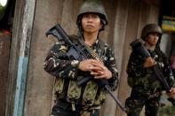 Philippines army soldiers patrol as government forces continue their assault against insurgents from the Maute group, who have taken over large parts of Marawi City, Philippines June 25, 2017. REUTERS/Jorge Silva