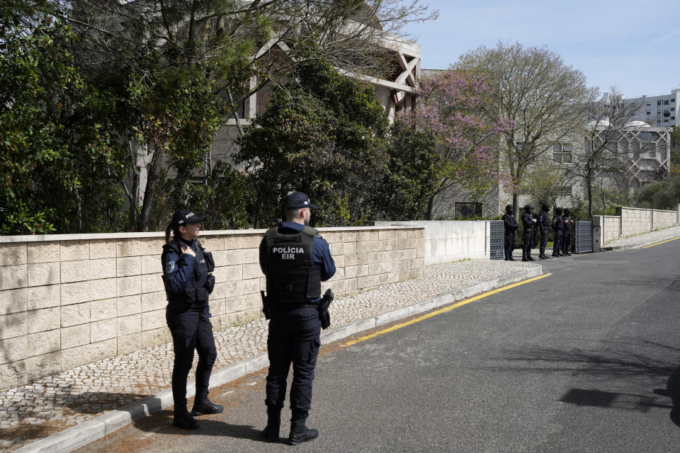 Police officers stand outside an Ismaili Muslim center in Lisbon, Portugal, Tuesday, March 28, 2023. Portuguese police have shot a man suspected of stabbing two people to death at an Ismaili Muslim center in Lisbon. Authorities said police were called to the center late Tuesday morning where they encountered a suspect armed with a large knife. (AP Photo/Armando Franca)