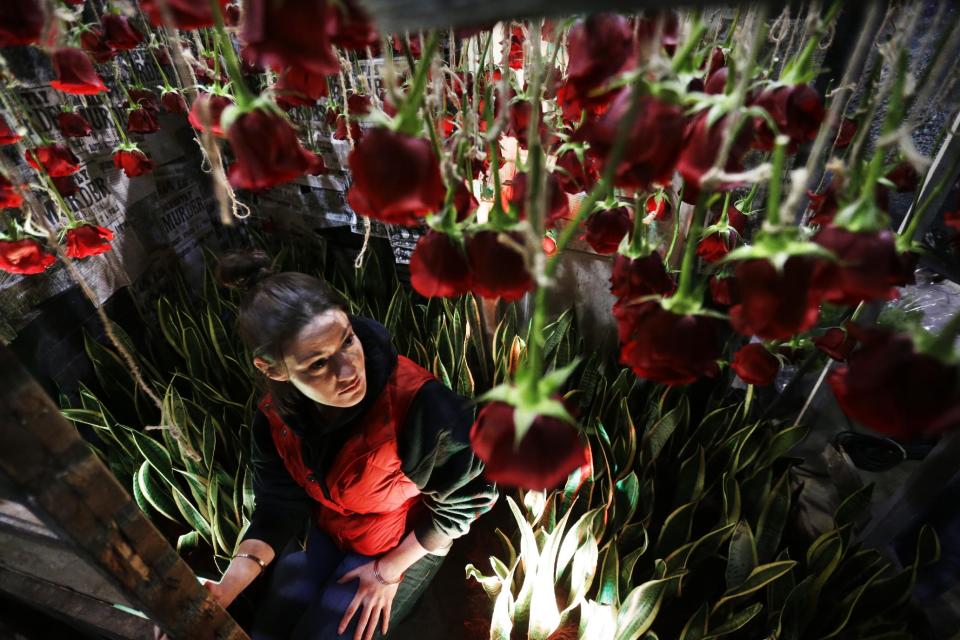 This Feb. 28, 2013 photo shows Shannon Toal with Schaffer Designs working on an installation titled "Jack," in preparation for the annual Philadelphia Flower Show at the Pennsylvania Convention Center in Philadelphia. More than 270,000 people are expected to converge on the Pennsylvania Convention Center for the event, which runs through March 10. Billed as the world's largest indoor flower show, it's also one of the oldest, dating back to 1829. (AP Photo/Matt Rourke)