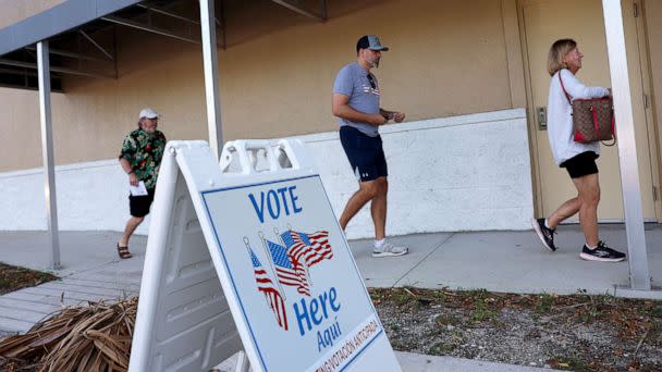 PHOTO: Voters arrive to cast their ballots at a polling station setup in the Lee County Election Headquarters building on Oct. 24, 2022, in Fort Myers, Fla. (Joe Raedle/Getty Images)