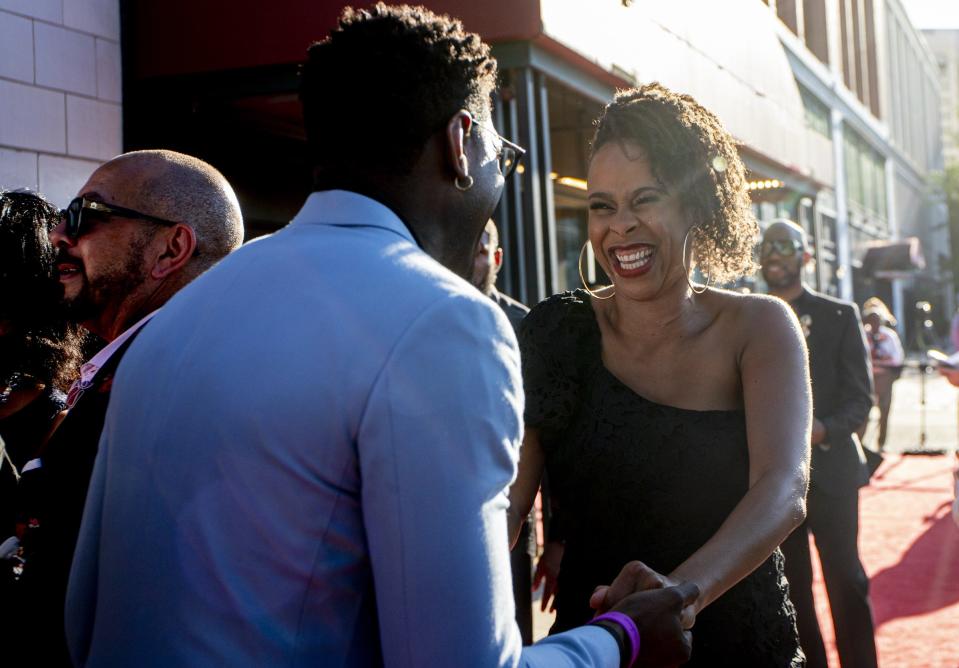 Dominique Morisseau greets the Temptations' Jawan Jackson at the red-carpet Detroit premiere of "Ain't Too Proud," the Temptations stage musical, at the Detroit Opera House on Wednesday, Aug. 10, 2022.